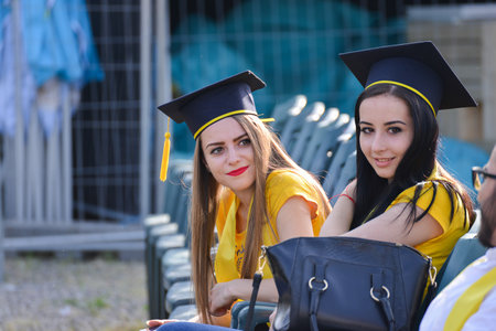 TIMISOARA, ROMANIA - May 4, 2018: university graduating students are having a photo shooting in the parkのeditorial素材