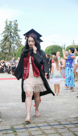 TIMISOARA, ROMANIA - June 09, 2019: university graduating students are having a photo shooting in the parkのeditorial素材