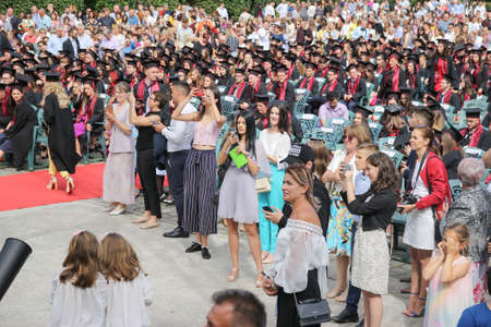 TIMISOARA, ROMANIA - June 09, 2019: university graduating students are having a photo shooting in the parkのeditorial素材