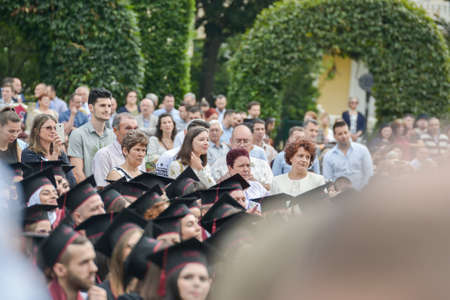 TIMISOARA, ROMANIA - June 09, 2019: university graduating students are having a photo shooting in the parkのeditorial素材