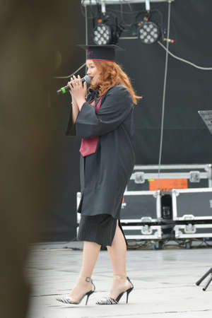 TIMISOARA, ROMANIA - June 09, 2019: university graduating students are having a photo shooting in the parkのeditorial素材