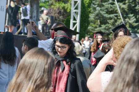 TIMISOARA, ROMANIA - June 09, 2019: university graduating students are having a photo shooting in the parkのeditorial素材