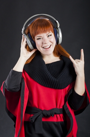 Girl with headphones over black backgroundの写真素材
