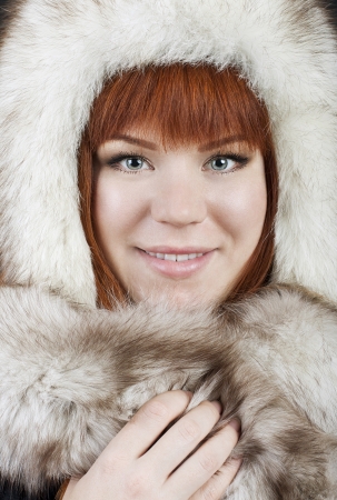 Beautiful red-haired girl in a fur hatの写真素材