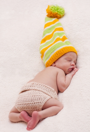 Close-up sleeping newbornon a white background with bright hatの写真素材