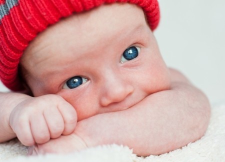 Cute blue-eyed infant with wide eyes in otkoytymi Shake on a white backgroundの写真素材