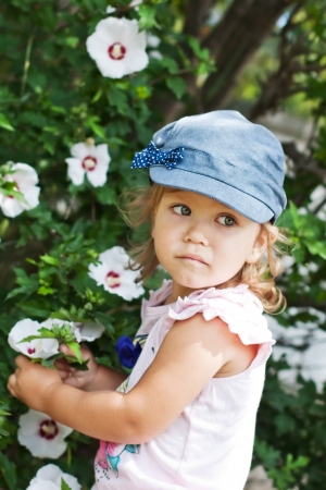 happy funny little girl with a flowerの写真素材