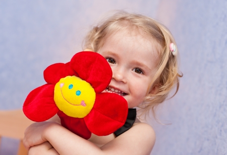 happy funny little girl with a flowerの写真素材