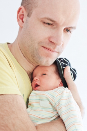 happy father with newborn son on a white backgroundの写真素材