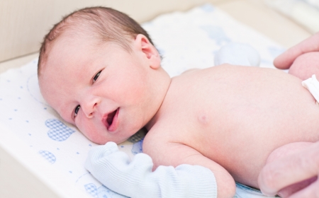 newborn baby in maternity hospital looking at the cameraの写真素材
