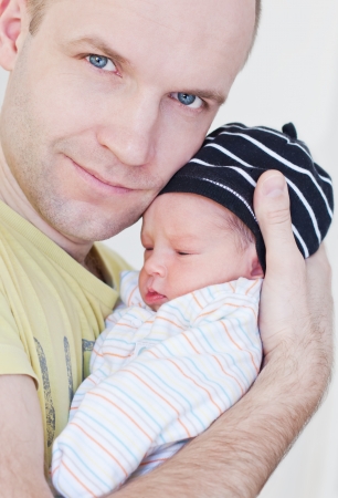 happy father with newborn son on a white backgroundの写真素材