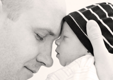 happy father with newborn son on a white backgroundの写真素材