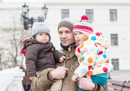 happy father and daughter and son for a walkの写真素材