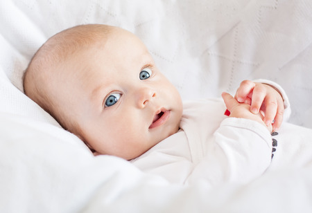 cute newborn baby smiling looking at the cameraの写真素材