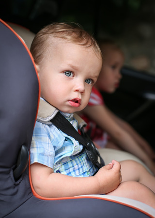 Cute toddler boy in car seat in the summerの写真素材