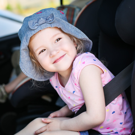 playful little girl in the car seatの写真素材