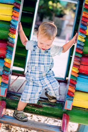 descends toddler boy at the playground in summerの写真素材