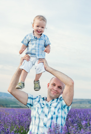 happy baby son with dad in lavender fieldの写真素材
