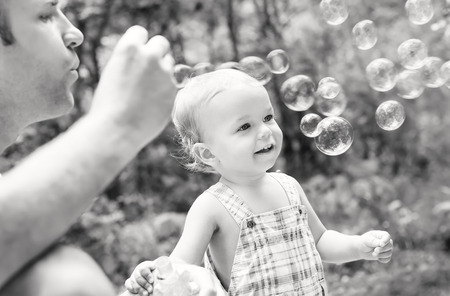 father playing with his son outdoors ( black and white )の写真素材