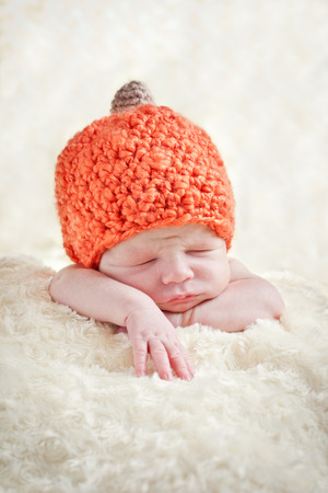 sweet sleeping baby with pumpkin hatの写真素材