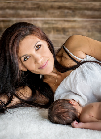 beautiful mother feeding her newborn with breastの写真素材