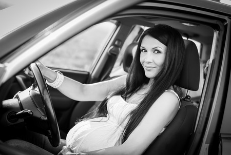 pregnant woman in driving seat of the car  の写真素材