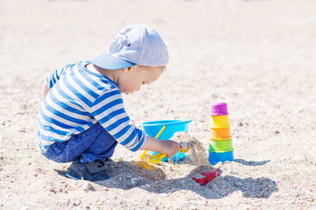 cute toddler boy playing on the beachの写真素材