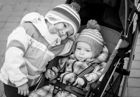 baby boy and toddler girl on the walk ( black and white )の写真素材
