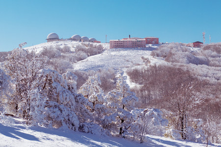 meteorological station high in the mountain in the winterの写真素材