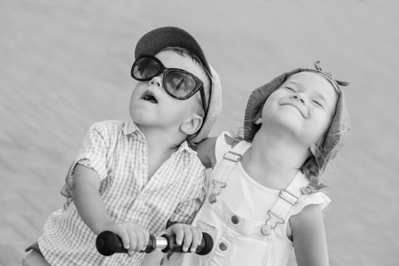 two little happy child play on a sunny day ( black and white )の写真素材