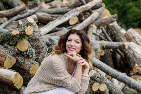 Beautiful young woman on the background of wood springの写真素材