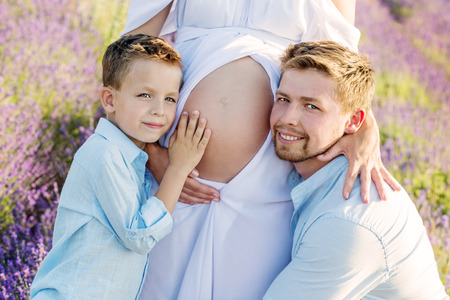 Happy young family outdoors in a lavender fieldの写真素材