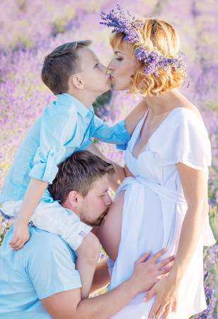 Happy young family outdoors in a lavender fieldの写真素材