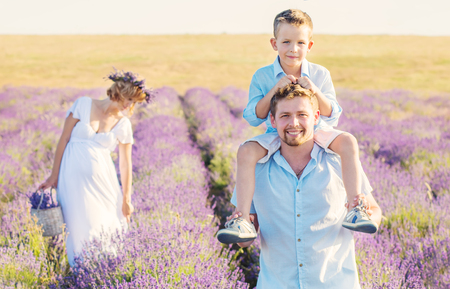 Happy young family outdoors in a lavender fieldの写真素材