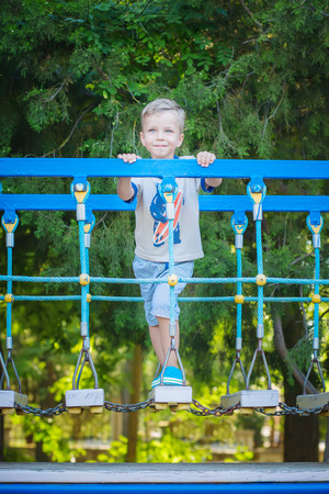 Portrait of happy little boy having fun in adventure park smilingの写真素材