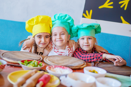 happy kids at a pizza cooking classの写真素材