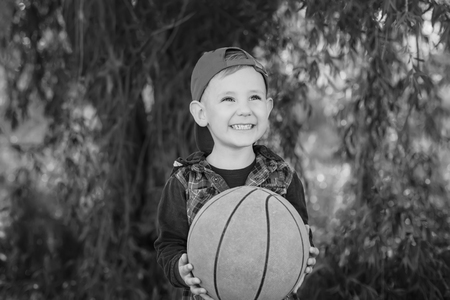A happy boy handing a basketball ( black and white )の写真素材