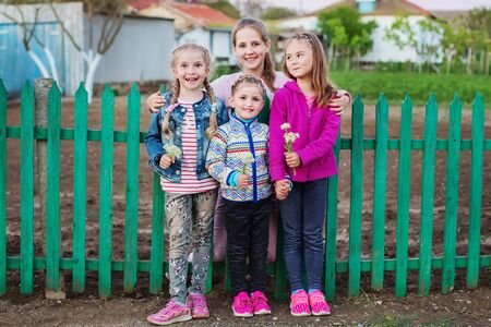 Four little girls cousins in the countryside have fun posingの写真素材