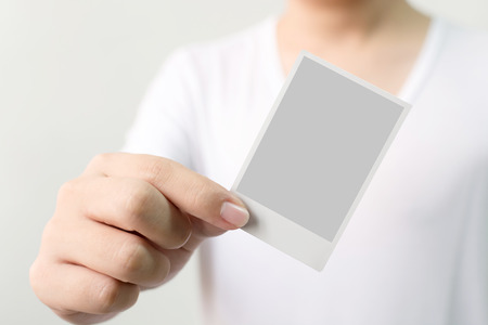 Hand of man holding photo frame, Clipping path includedの写真素材