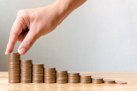 Hand of male or female putting coins stack step growing growth saving money, Concept finance business investmentの写真素材