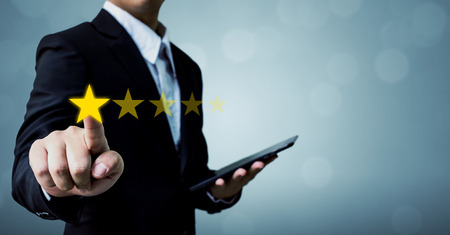 Review and rating increase company concept, Businessman hand touching five star