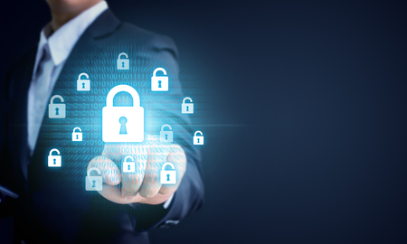 Businessman pointing virtul lock key, Data protection business cyber security technology conceptの写真素材