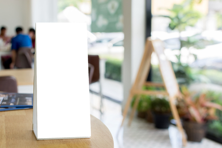 Mock up blank template menu frame on wood table in restaurant with blurred backgroundの写真素材