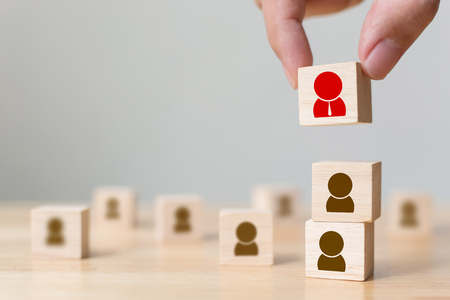Human resource management and recruitment business build team concept, Hand putting wood cube block on top, Copy space Human resource management and recruitment business build team concept, Hand putting wood cube block on top, Copy space