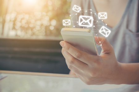 Asian woman hand using mobile phone with e-mail application, Concept email newsletter and antivirus spam mail protectionの写真素材