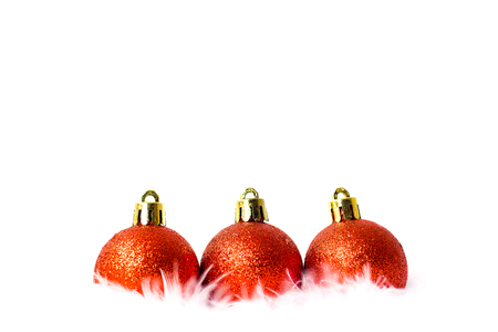 Christmas ball red color and white feather on white background, Copy space for your textの写真素材