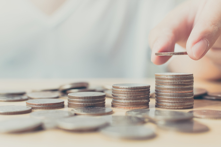 Saving money for investment concept, Hand of male or female putting coin stack step growing growth financialの写真素材