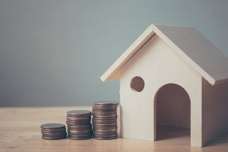 Property investment and house mortgage financial concept, House model and coin money on table for finance and bankingの写真素材