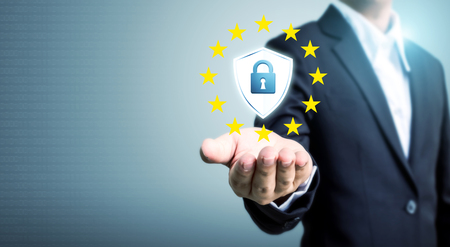 Businessman hand holding sign general data protection regulation (GDPR) and shield with key iconの写真素材
