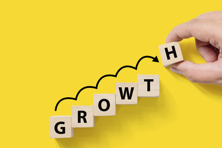 Business success growing growth increase up concept. Wooded cube block on white background with word GROWTH and copy space for your textの写真素材